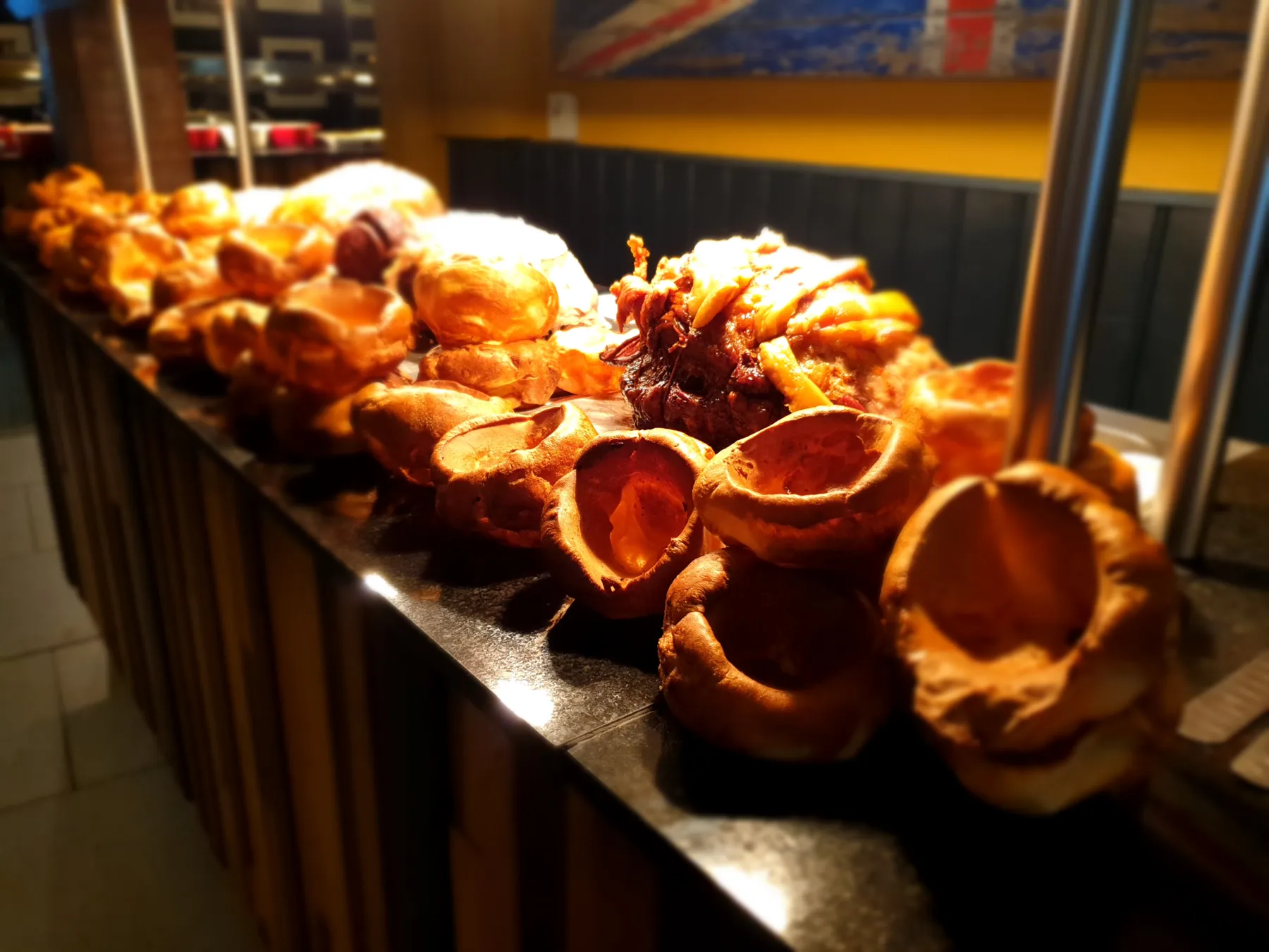 Freshly baked Yorkshire puddings lined up along the carvery counter